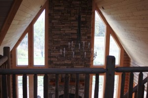 Great Room ceiling (tongue and groove cedar boards), chimney (cultured ledgestone) and chandelier taken from the loft
