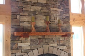 Fireplace mantle made of reclaimed hemlock wood with solid cherry corbels