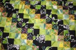 Batik (around the world pattern) quilt made by Corey's co-worker Mary Lu