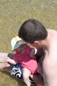 Daddy swirling my legs in the lake...I like the bath tub better...